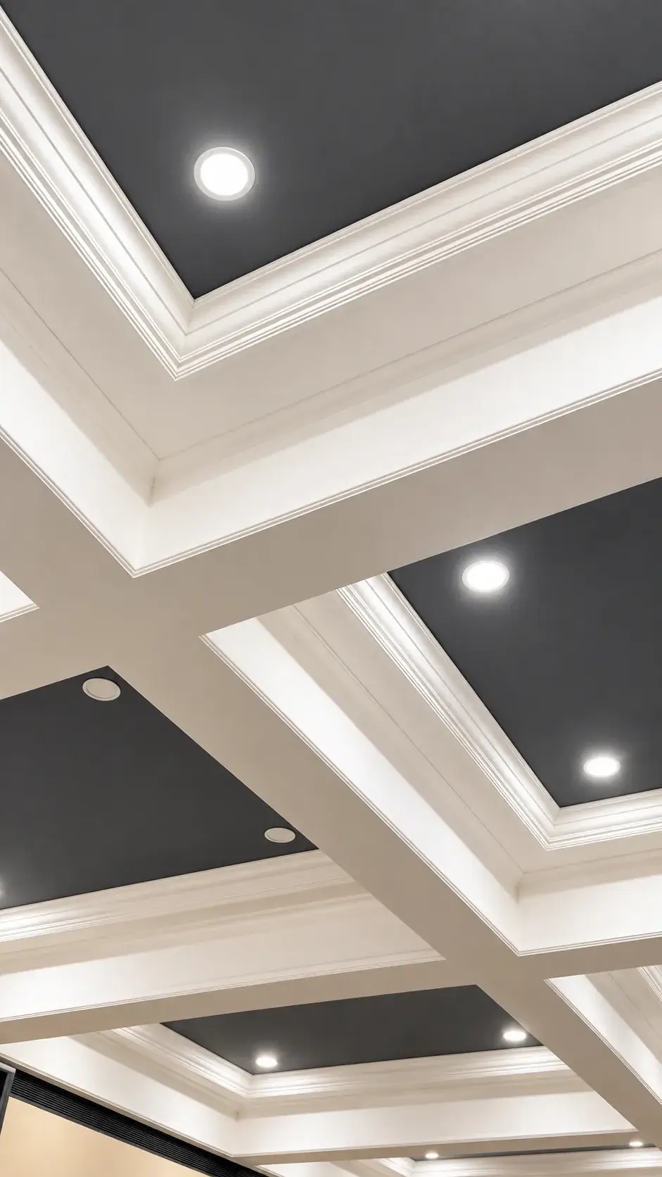 Classic white coffered ceiling grid with matte charcoal recesses and round recessed lights